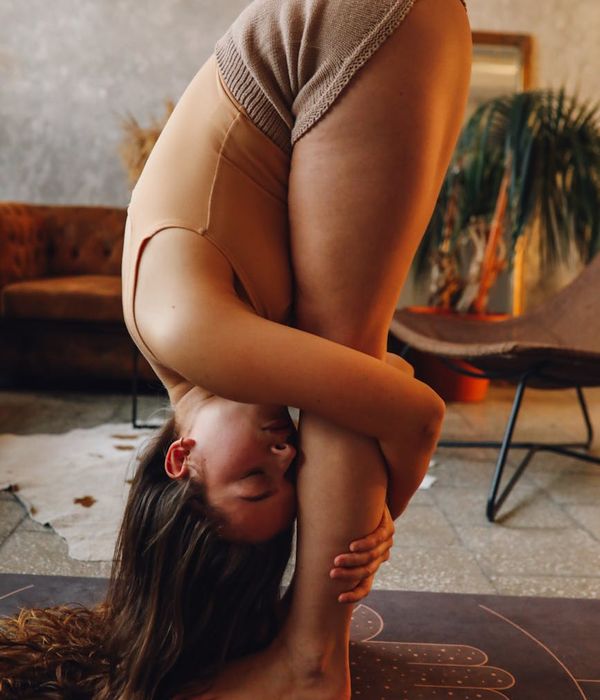 Person holding a stable and strong yoga pose on a mat.