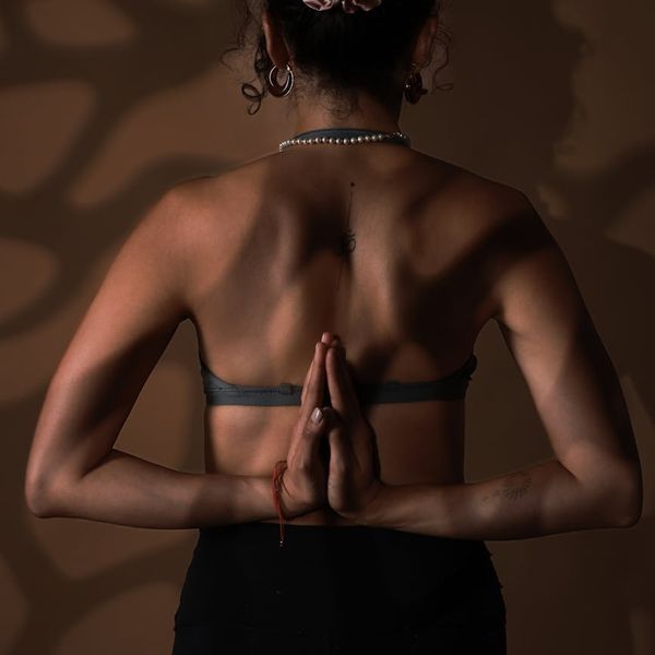 Woman in a calm yoga pose, embodying conscious movement.